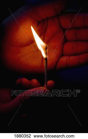 Stock Image - Lighing A Match, Close Up. Fotosearch