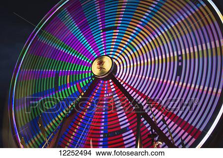 Light effect of a fairground ride at night at the Calgary Stampede; Calgary, Alberta, Canada View Large Photo Image Picture - Light effect of a fairground ride at night at the Calgary Stampede; Calgary, Alberta, Canada. Fotosearch