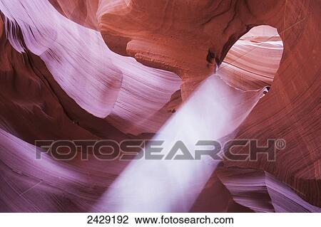 Stock Image - Light falls through arch in slot canyon formation near Page; Arizona, United States of America. Fotosearch