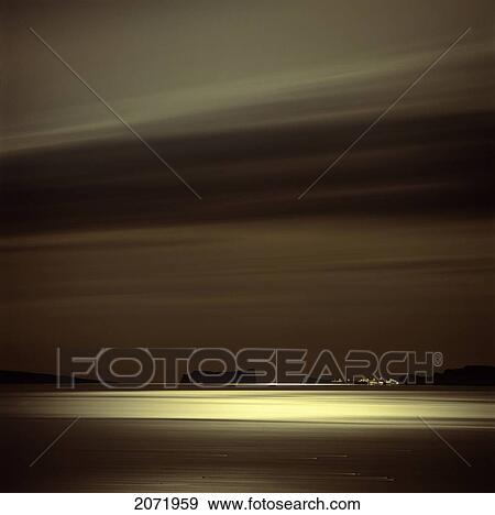 Stock Photo - Light Of The Moon Over Saint-Georges De La Malbaie And Perce Rock, Gaspe Coast, Quebec. Fotosearch