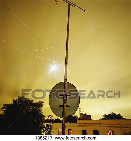 Light Trails In Sky At Night Above Houses And Street Sign View Large Photo Image Stock Photo - Light Trails In Sky At Night Above Houses And Street Sign. Fotosearch