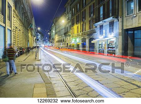 Light trails of headlights and taillights down a street; Milan, Lombardy, Italy View Large Photo Image Stock Image - Light trails of headlights and taillights down a street; Milan, Lombardy, Italy. Fotosearch