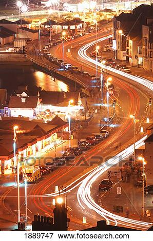 Stock Photo - Light Trails On Curved Road At Night, Aerial View. Fotosearch