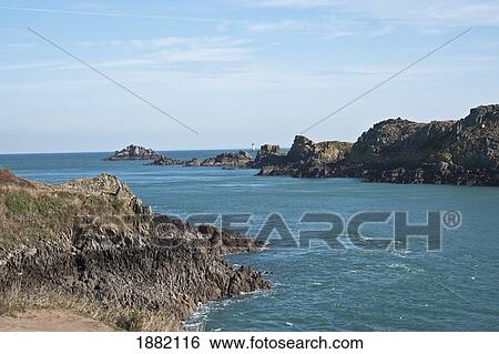 Stock Photograph - Lighthouse In The Distance; Pointe Du Grouin, France. Fotosearch