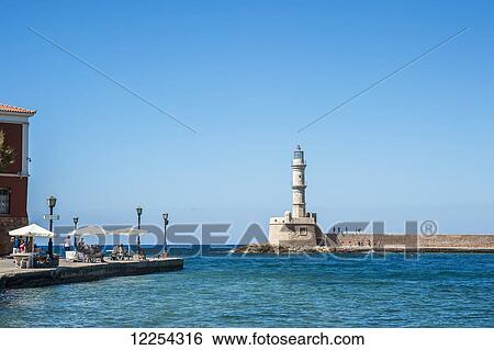 Stock Photograph - Lighthouse in the Venetian harbour; Chania, Crete, Greece. Fotosearch