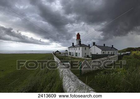Stock Photo - Lighthouse on the coast under storm clouds; South Shields, Tyne and Wear, England. Fotosearch
