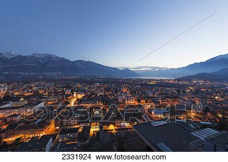 Lights Illuminate The Buildings At Dusk And Lake Maggiore; Locarno, Ticino, Switzerland View Large Photo Image Picture - Lights Illuminate The Buildings At Dusk And Lake Maggiore; Locarno, Ticino, Switzerland. Fotosearch