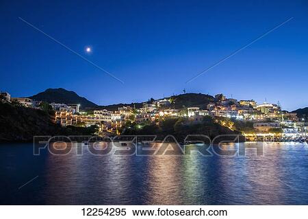 Lights illuminate the city and reflect on the water; Bali, Crete, Greece View Large Photo Image Stock Photography - Lights illuminate the city and reflect on the water; Bali, Crete, Greece. Fotosearch
