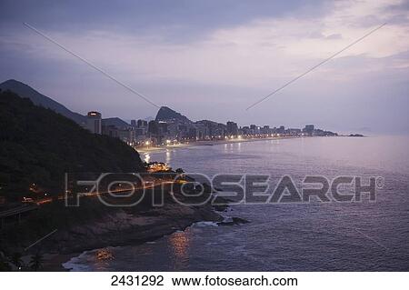 Stock Image - Lights illuminate the urban coastline; Rio de Janeiro, Brazil. Fotosearch