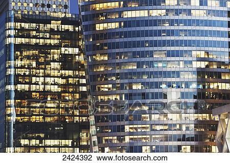 Stock Image - Lights on in office towers; Paris, France. Fotosearch