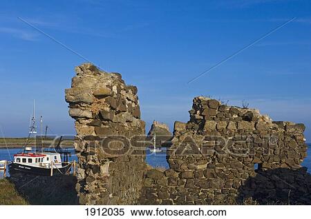 Stock Photography - Lindesfarne Castle Seen Through Breach In Stone Wall, Holy Island, Northumberland, Uk. Fotosearch