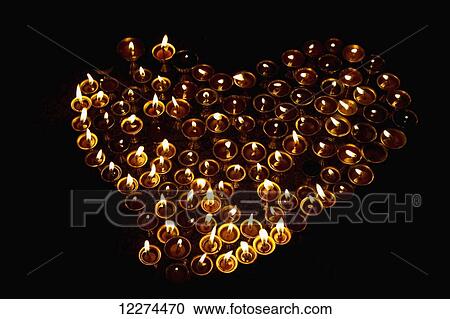 Stock Image - Lit butter lamps in the interior of Migjed Janraisig Temple at the Gandan Monastery (Gandantegchinlen Khiid), Ulaanbaatar (Ulan Bator), Mongolia. Fotosearch