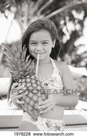 Stock Photo - Little Girl Drinking From Pineapple (Sepia Photograph).. Fotosearch