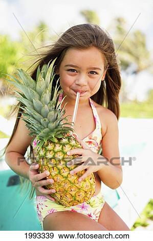 Stock Photo - Little Girl Drinking From Pineapple.. Fotosearch