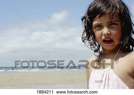 Stock Image - Little Girl On The Beach, Portrait. Fotosearch
