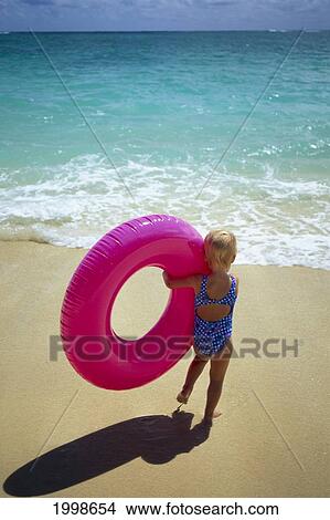 Little Girl Runs To Water With Beach Tube B1078 View Large Photo Image Picture - Little Girl Runs To Water With Beach Tube B1078. Fotosearch