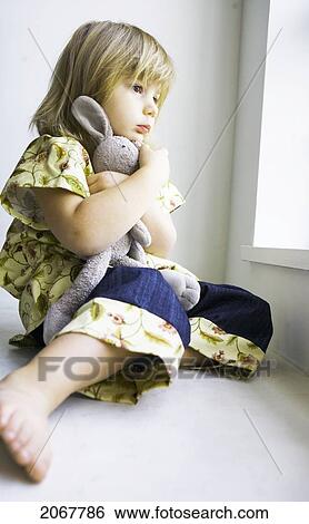Little Girl Staring Out A Window Holding A Stuffed Bunny, Vancouver, British Columbia View Large Photo Image Stock Photograph - Little Girl Staring Out A Window Holding A Stuffed Bunny, Vancouver, British Columbia. Fotosearch
