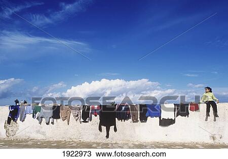 Stock Image - Little Girl Watching Laundry Dry, Blv Sidi Mohamed Ben Abdalalh. Fotosearch
