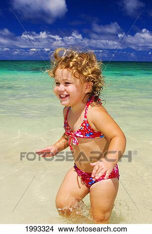 Little Girl With Blond Curly Hair Plays In The Ocean View Large Photo Image Picture - Little Girl With Blond Curly Hair Plays In The Ocean. Fotosearch