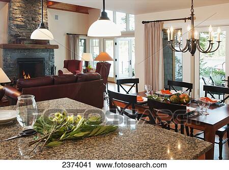 Stock Image - Living Room And Dining Area Of Home With An Ocean View; Mayne Island, British Columbia, Canada. Fotosearch
