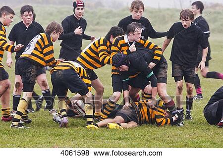 Stock Photo - Local boys rugby match, St. David's versus Neyland, held at St. David's rugby club on a rainy day, Pembrokeshire Coast Path, South West Wales; Pembrokeshire, Wales. Fotosearch