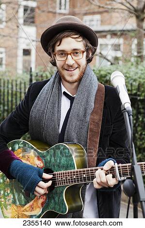 Stock Image - Local busker at Portobello Market; London, England. Fotosearch