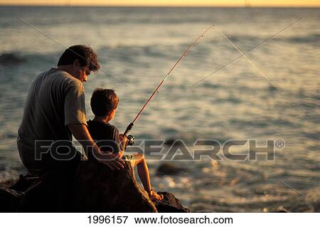 Local Family, Father And Son Fishing At Sunset On Rocks By Ocean View Large Photo Image Stock Photo - Local Family, Father And Son Fishing At Sunset On Rocks By Ocean. Fotosearch