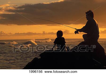 Stock Photograph - Local Family, Father And Son Fishing At Sunset With Dramatic Foreground Light. Fotosearch