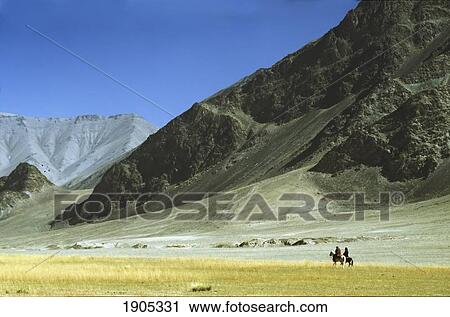 Stock Image - Local Horsemen In Pamirs Mountains, Xinjiang, China. Fotosearch
