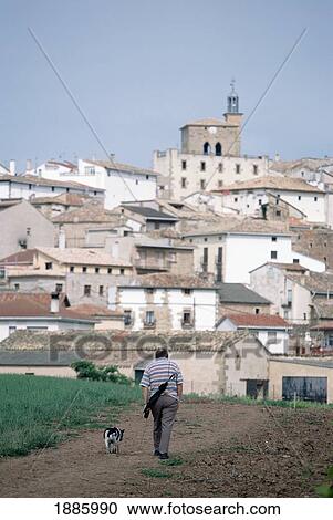 Stock Image - Local Man And Dog On Path To Cirauqui Village. Fotosearch