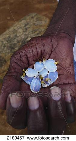 Stock Photo - Local Man Holds Violet-Colored Moonstones In His Dark Hand, Mahabalipuram, Tamil Nadu, India. Fotosearch