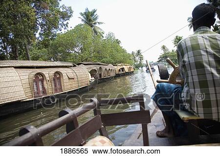 Local Man Steering House Boat On Backwaters View Large Photo Image Stock Photography - Local Man Steering House Boat On Backwaters. Fotosearch