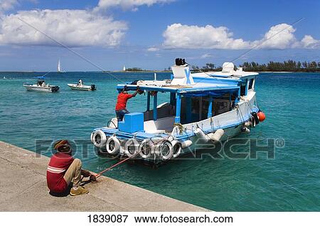 Local People On Boat In Nassau Harbor; Nassau, New Providence Island, Bahamas View Large Photo Image Stock Photo - Local People On Boat In Nassau Harbor; Nassau, New Providence Island, Bahamas. Fotosearch