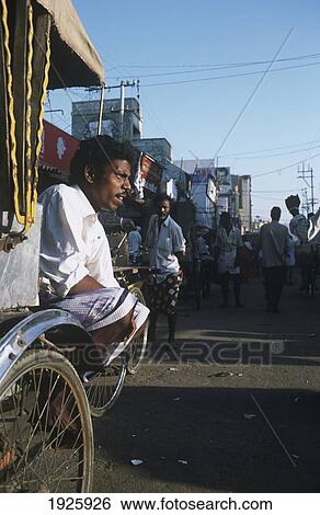 Stock Photograph - Local Sitting On His Rickshaw. Fotosearch