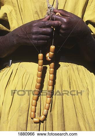 Stock Photograph - Local Woman Holding Necklace, Mid Section. Fotosearch