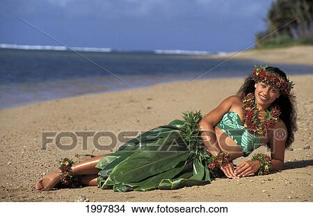 Picture - Local Woman In Hula Attire Laying On The Beach. Fotosearch