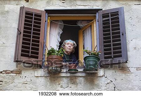 Local woman looks from her window in Old Town Rovinj, Istria, Croatia. View Large Photo Image Stock Photo - Local woman looks from her window in Old Town Rovinj, Istria, Croatia.. Fotosearch