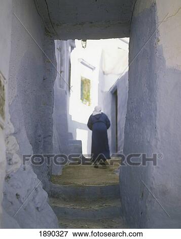 Local Woman Walking In Alley Of Medina (Walled Town) View Large Photo Image Stock Photo - Local Woman Walking In Alley Of Medina (Walled Town). Fotosearch