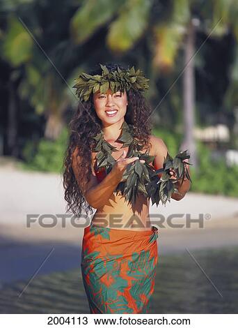 Stock Image - Local Woman With Haku On Head, Holds Lei, Smiling Wears Orange And Green Pareo. Fotosearch
