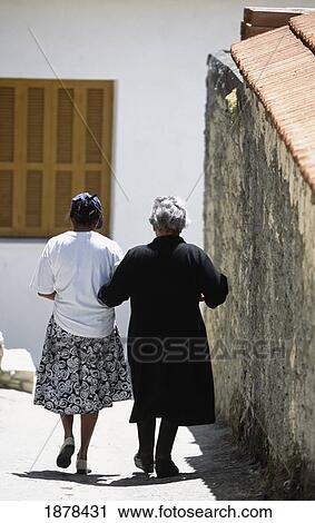 Stock Image - Local Women Walking Along The Street In Omodos. Fotosearch