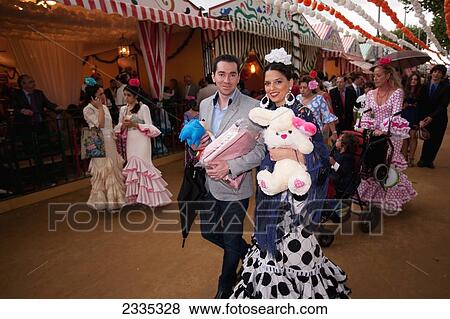 Stock Photo - Locals In Traditional Seville Dresses During April Feria Festival; Seville, Andalucia, Spain. Fotosearch