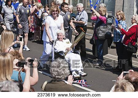 Stock Photo - London 2012 Olympic torch on relay tour of United Kingdom prior to Summer Olympics; Shepton Mallet, Somerset, England. Fotosearch