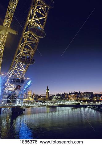 Stock Photograph - London Eye And Houses Of Parliament At Dusk. Fotosearch