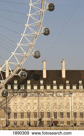 Stock Photo - London Eye Capsules, Former City Hall Building In Background. Fotosearch