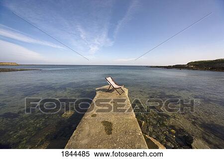 Lonely Deckchair At The Edge Of Pier; Northumberland, England, Uk View Large Photo Image Stock Photography - Lonely Deckchair At The Edge Of Pier; Northumberland, England, Uk. Fotosearch