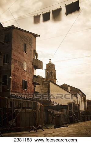 Long exposure of clothing drying on a clothesline moving in the breeze in the Castello district; Venice, Italy View Large Photo Image Stock Photo - Long exposure of clothing drying on a clothesline moving in the breeze in the Castello district; Venice, Italy. Fotosearch
