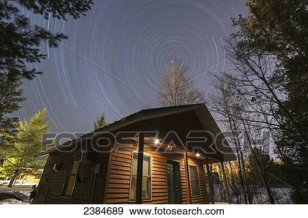 Long exposure of stars in the night sky over a cabin; Bayfield, Wisconsin, United States of America View Large Photo Image Stock Photo - Long exposure of stars in the night sky over a cabin; Bayfield, Wisconsin, United States of America. Fotosearch
