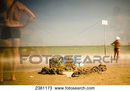 Stock Image - Long exposure of sunbathers on the beach at Venice Lido; Venice, Italy. Fotosearch