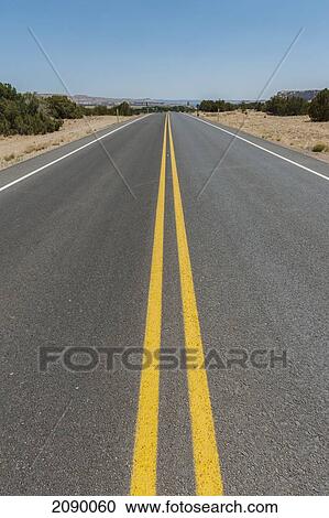 Stock Image - Long Straight Road, New Mexico, Usa. Fotosearch