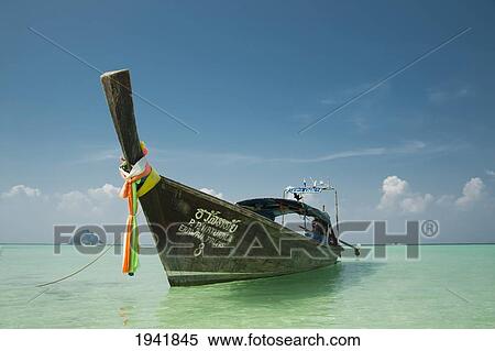 Stock Photography - Long-Tail Boat With Mosquito Island In The Background; Phi Phi Islands Phuket Thailand. Fotosearch